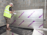 An Ecotherm Eco-Versal insulation board being held by an installer ready to be laid on the floor